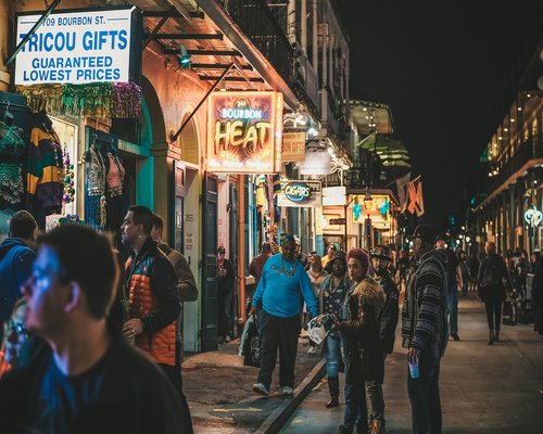 A person walking through a busy city street in the evening