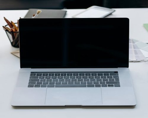 A closed laptop on a clean desk at the end of the day